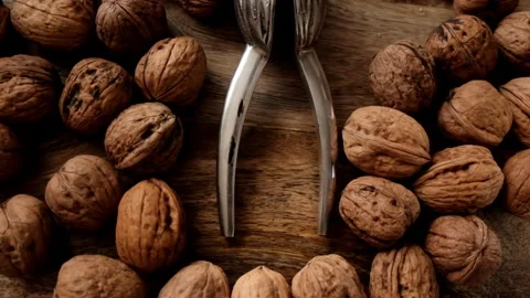 Walnuts and nutcracker on wooden background. Stock Footage 144067354