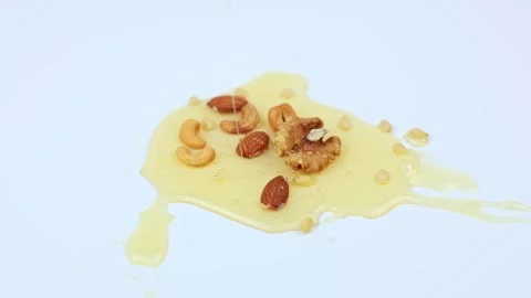 Walnuts and pine nuts, almonds and cashews lie on a white background in a puddle Stock Footage 307168016
