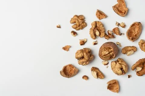 Walnuts and shells on white background. Natural healthy food concept emphasiz Stock Photos