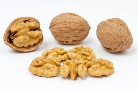 Walnuts and walnut kernels on white background Stock Photos