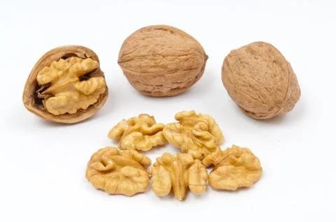 Walnuts and walnut kernels on white background Stock Photos