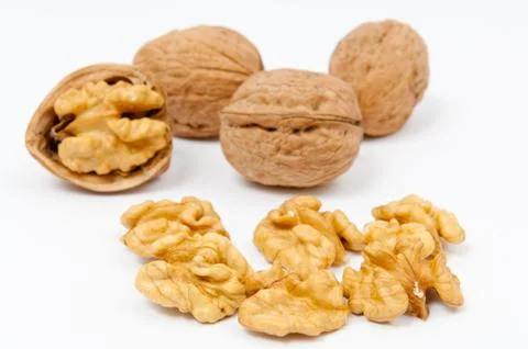 Walnuts and walnut kernels on white background Stock Photos