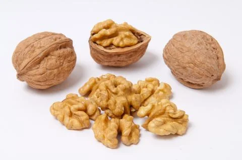 Walnuts and walnut kernels on white background Stock Photos