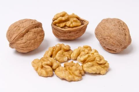 Walnuts and walnut kernels on white background Stock Photos