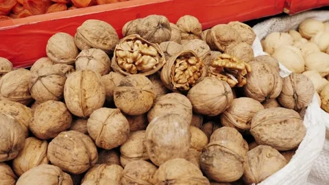 Walnuts with and without shells on market. Background of fresh walnuts. Stock Footage 224913317