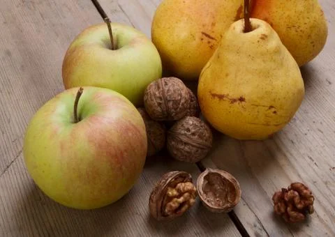 Walnuts, apples and pears Stock Photos