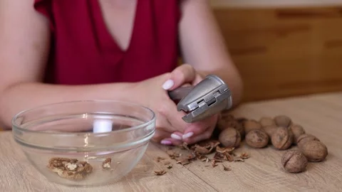 Walnuts are crushed using a walnut sheller. Walnuts are a useful ingredient f Stock Footage 316582494
