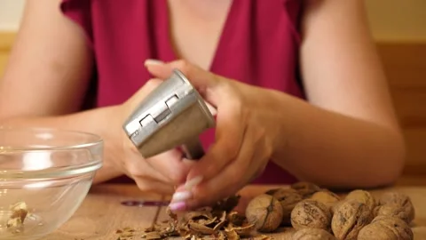 Walnuts are crushed using a walnut sheller. Walnuts are a useful ingredient f Stock Footage 316583067