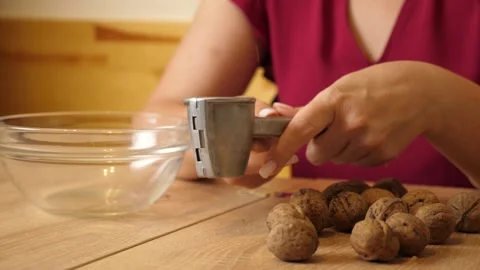 Walnuts are crushed using a walnut sheller. Walnuts are a useful ingredient f Stock Footage 316583068