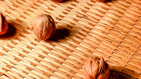 Walnuts are dropped in bamboo baskets. Slow motion. 스톡 동영상 145350015