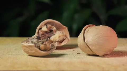 Walnuts are smashed with a hammer, walnuts are cracked, Slow motion Stock Footage 264876746