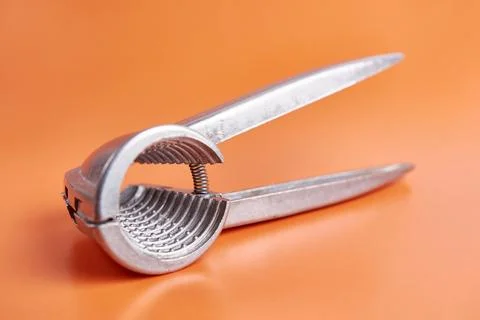 Walnuts are split with a nutcracker. Kitchen appliances for work in the kit.. Stock Photos