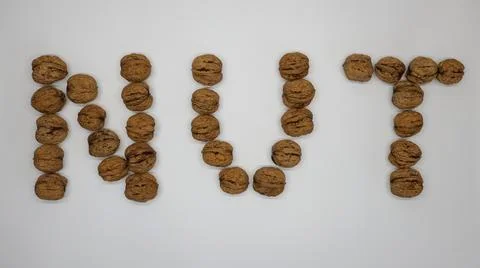 Walnuts arranged in the word "NUT" Stock Photos