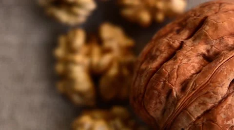 Walnuts with Autumn Leaves on Brown Background Stock Footage 59086943