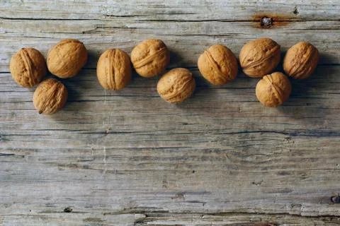 Walnuts on the background of an old board. top view Stock Photos