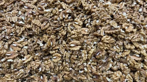 Walnuts background showing textured natural shells and kernels for culinary.. Stock Footage 333130482