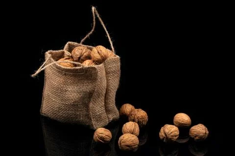 Walnuts in the bag on a black background. 스톡 사진