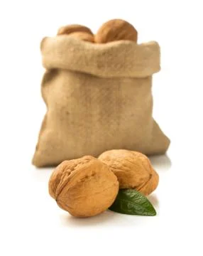 Walnuts in bag on white background Stock Photos