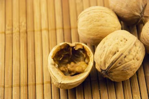 Walnuts on a bamboo mat Stock Photos