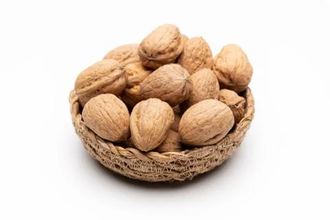 Walnuts in basket on white background Stock Photos