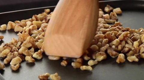 Walnuts being roasted in a pan Stock Footage 8574843