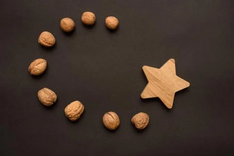 Walnuts on a black background and an oak star Stock Photos
