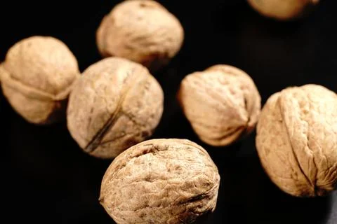 Walnuts on a black background. The light was dim. Stock-Fotos