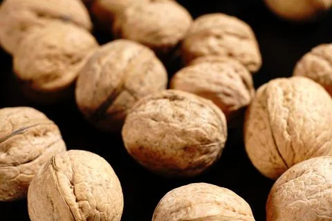Walnuts on a black background. The light was dim. Stock Photos