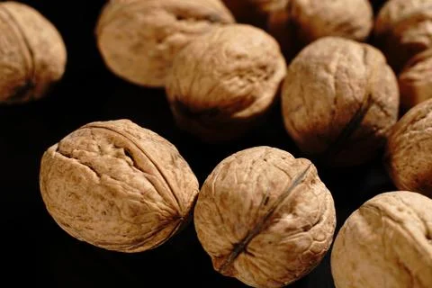 Walnuts on a black background. The light was dim. Stock Photos