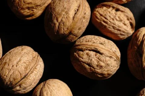 Walnuts on a black background. The light was dim. Stock Photos