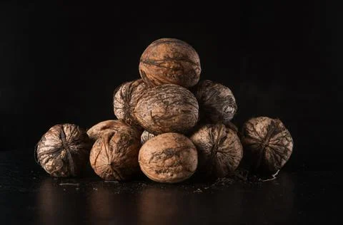 Walnuts on a black background Stock Photos
