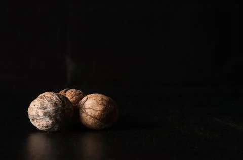 Walnuts on a black background Stock Photos