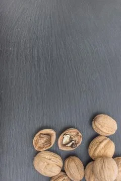 Walnuts on black background of slate or stone Stock Photos