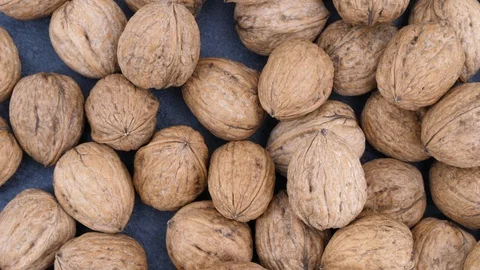 Walnuts on black stone loop rotating Stock Footage 85953800