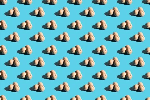 Walnuts on a blue background. A pattern of walnuts on a blue background. Hard Stock Photos