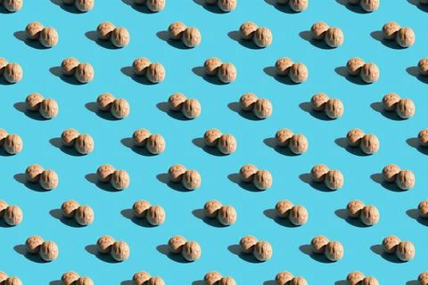 Walnuts on a blue background. A pattern of walnuts on a blue background. Hard Stock Photos