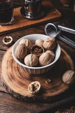 Walnuts in bowl and nutcracker Stock Photos