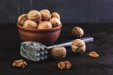 Walnuts in a bowl with a hammer Stock Photos
