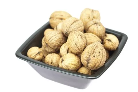 Walnuts in a bowl isolated on white Stock Photos