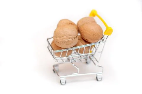 Walnuts in a cart on a white background Stock Photos