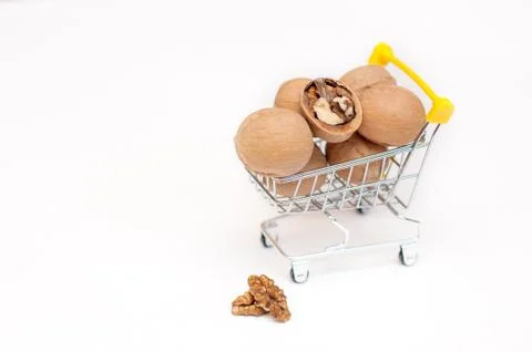 Walnuts in a cart on a white background Stock Photos