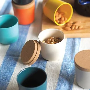 Walnuts in ceramic bowl on kitchen table Stock Photos