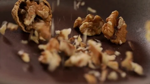 Walnuts Chopped Fall into Pan closeup Stock Footage 99165702
