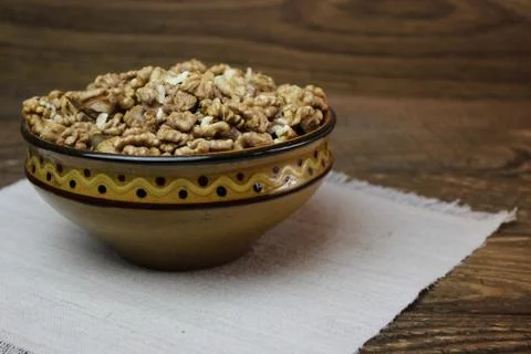 Walnuts in a clay plate Photos