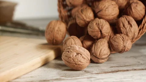 Walnuts coming out and rolling out of the basket in slow motion Stock Footage 152176079
