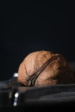 Walnuts on a dark background. Nutcracker close-up. Stock Photos