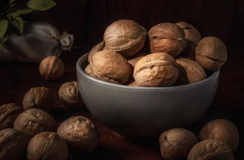 Walnuts on a dark background in a rustic style Stock Photos