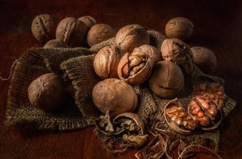 Walnuts on a dark background in a rustic style Stock Photos