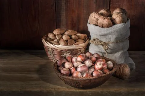 Walnuts on a dark wooden background in a rustic style Stock Photos