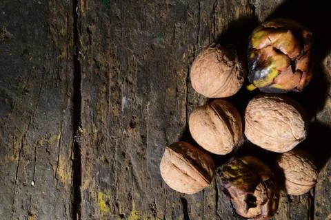 Walnuts on a dark wooden table Stock Photos